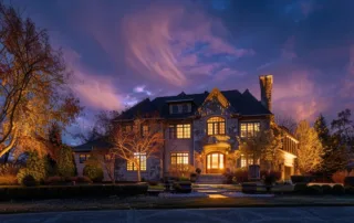 a stunningly illuminated home in overland park, shining brightly against the night sky.